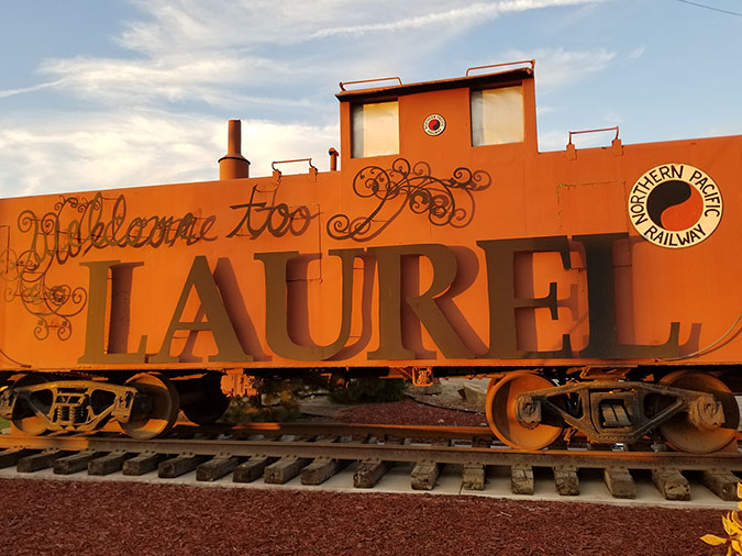 Welcome to Laurel sign in the shape of a caboose with Northern Pacific Railway logos