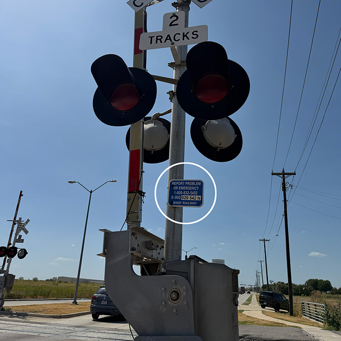 Location of the ENS sign on a grade crossing signal.
